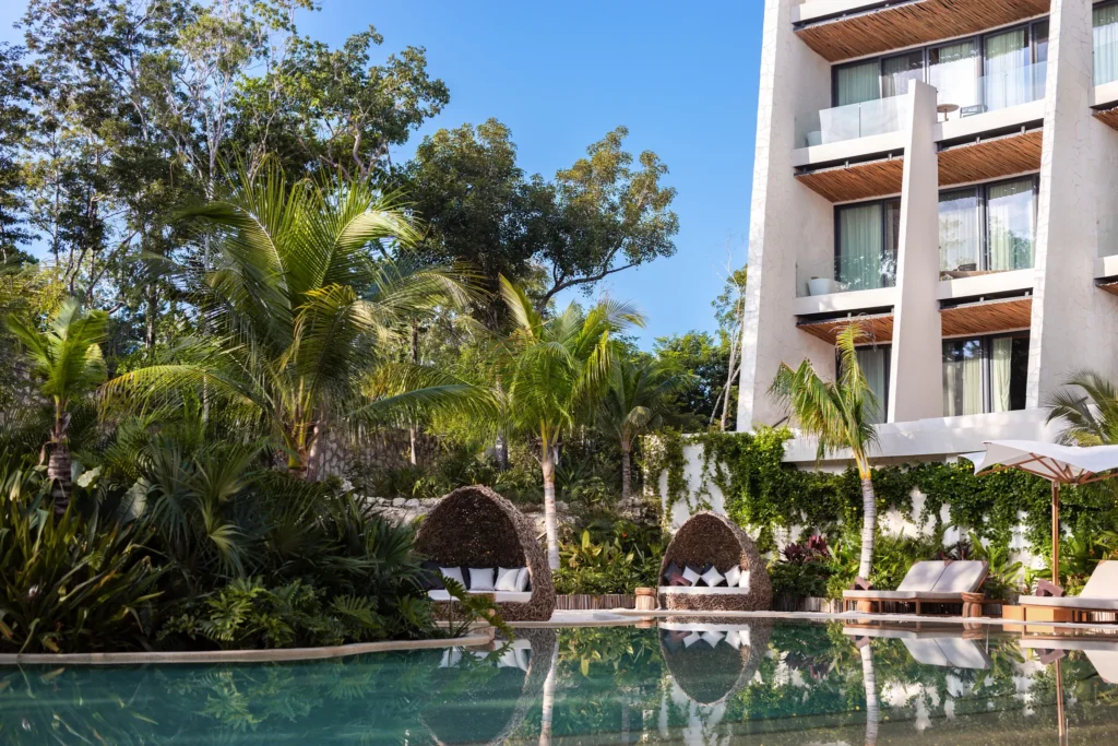 Lagoon-style pool surrounded by tropical gardens at Secrets Tulum Resort & Beach Club.