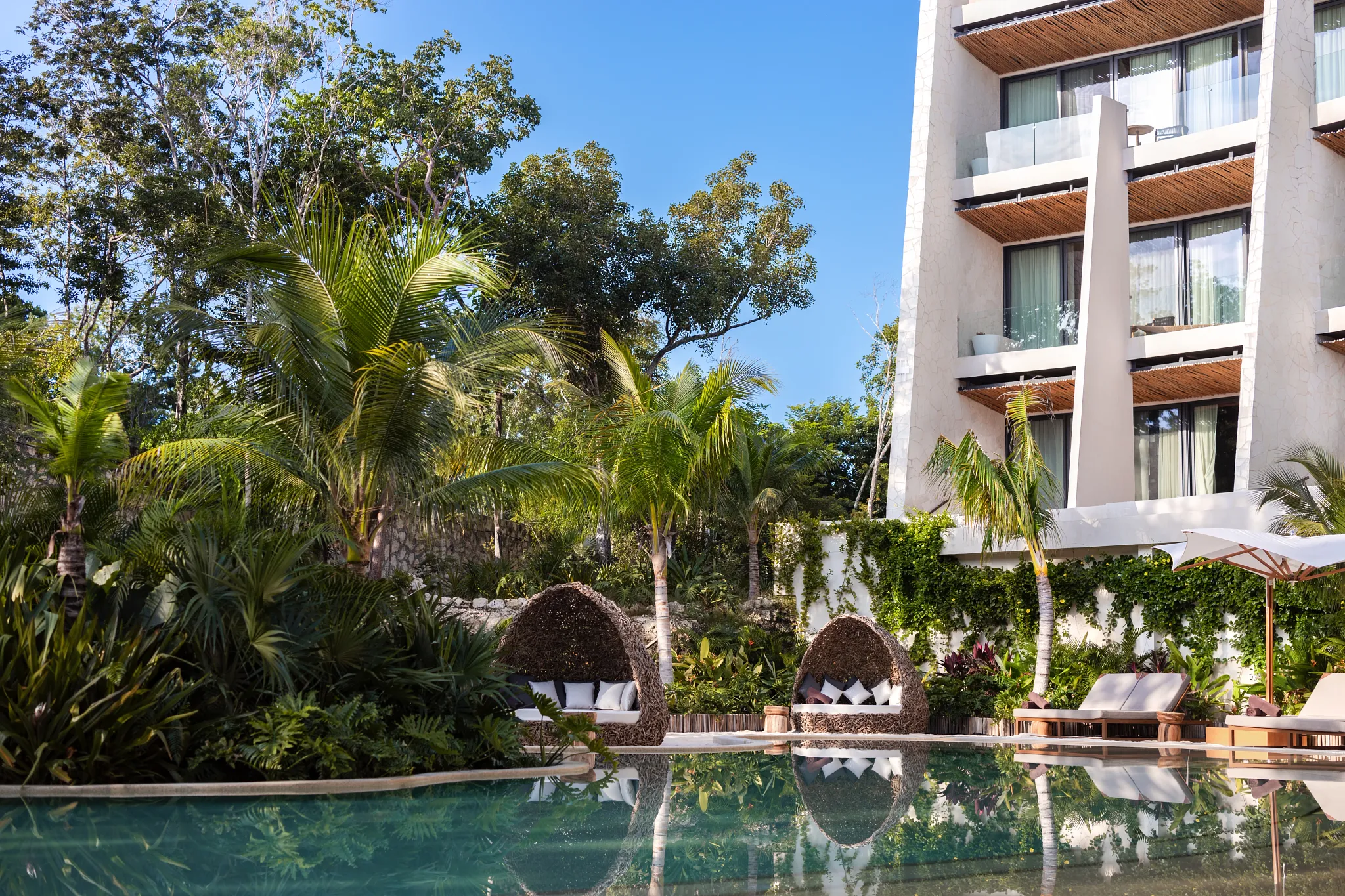Lagoon-style pool surrounded by tropical gardens at Secrets Tulum Resort & Beach Club.