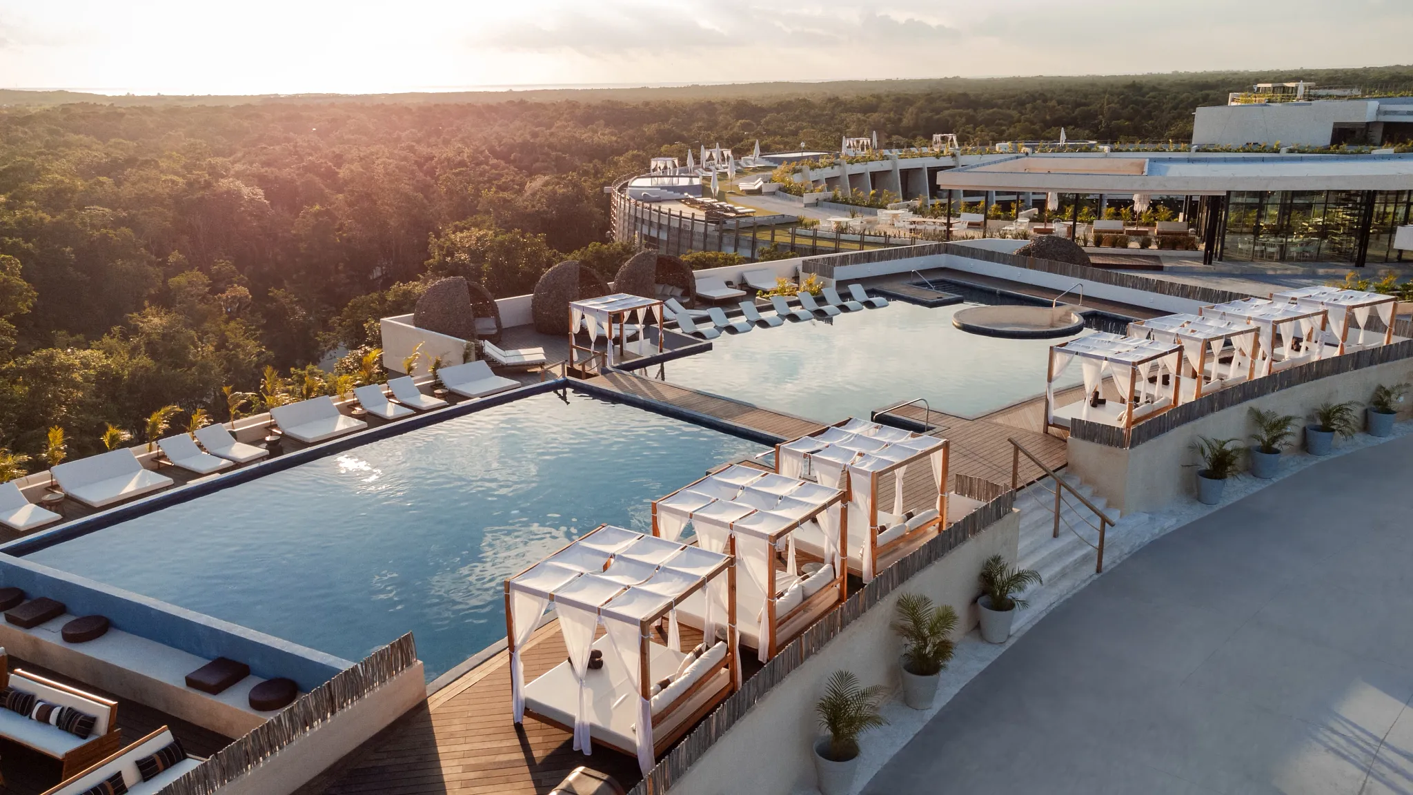 Rooftop pools with luxury cabanas overlooking the jungle at Secrets Tulum Resort & Beach Club.