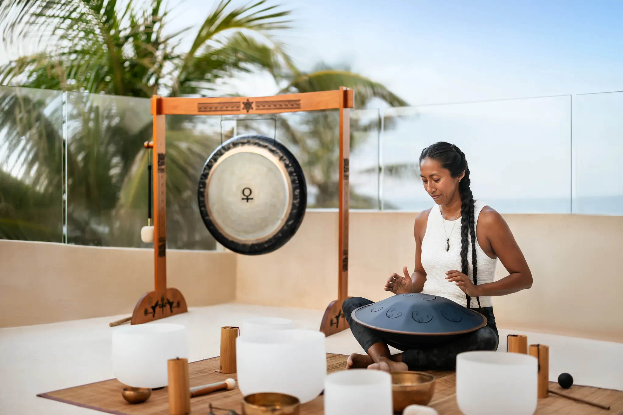 Sound healing meditation session with singing bowls at Secrets Tulum Resort & Beach Club.