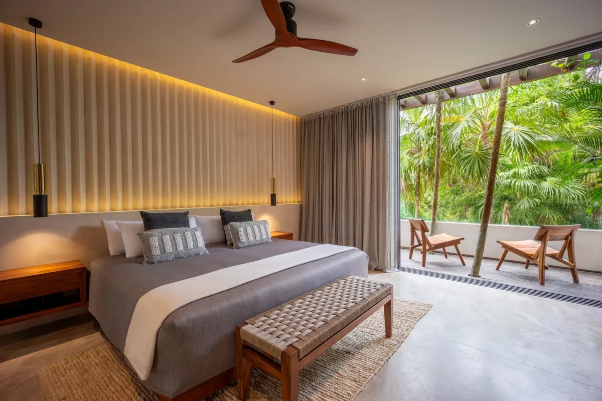 Villa Zamna guest king bedroom with private furnished terrace at Secrets Tulum Resort & Beach Club.