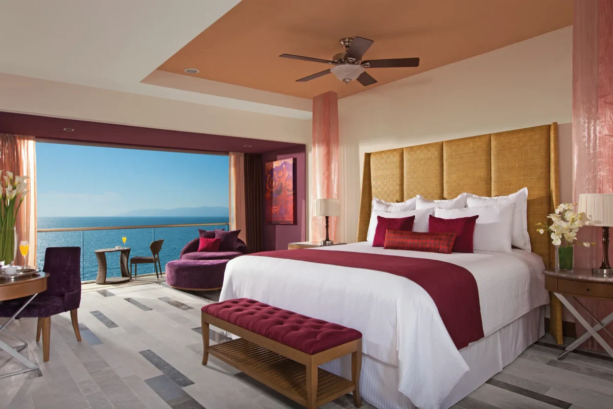 Junior Suite Ocean View with king bed, sitting area, and balcony overlooking the ocean at Secrets Vallarta Bay Puerto Vallarta.