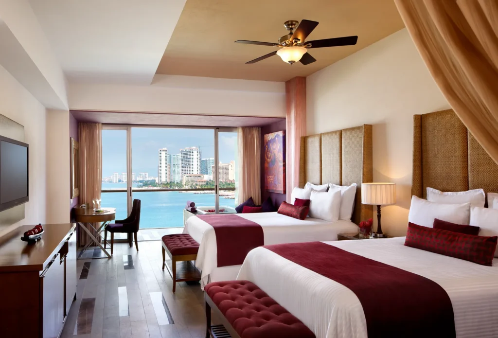 Preferred Club Junior Suite Ocean View with two double beds and balcony overlooking the ocean at Secrets Vallarta Bay Puerto Vallarta.