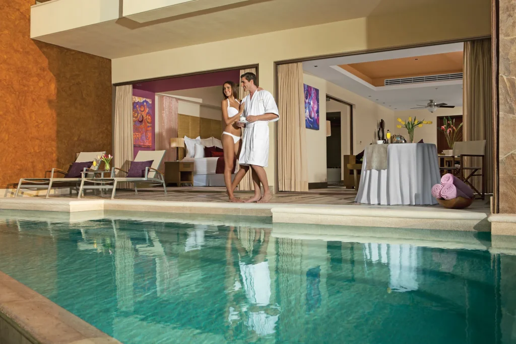 Preferred Club Master Suite Swim Out terrace with pool access and couple enjoying outdoor space at Secrets Vallarta Bay Puerto Vallarta.