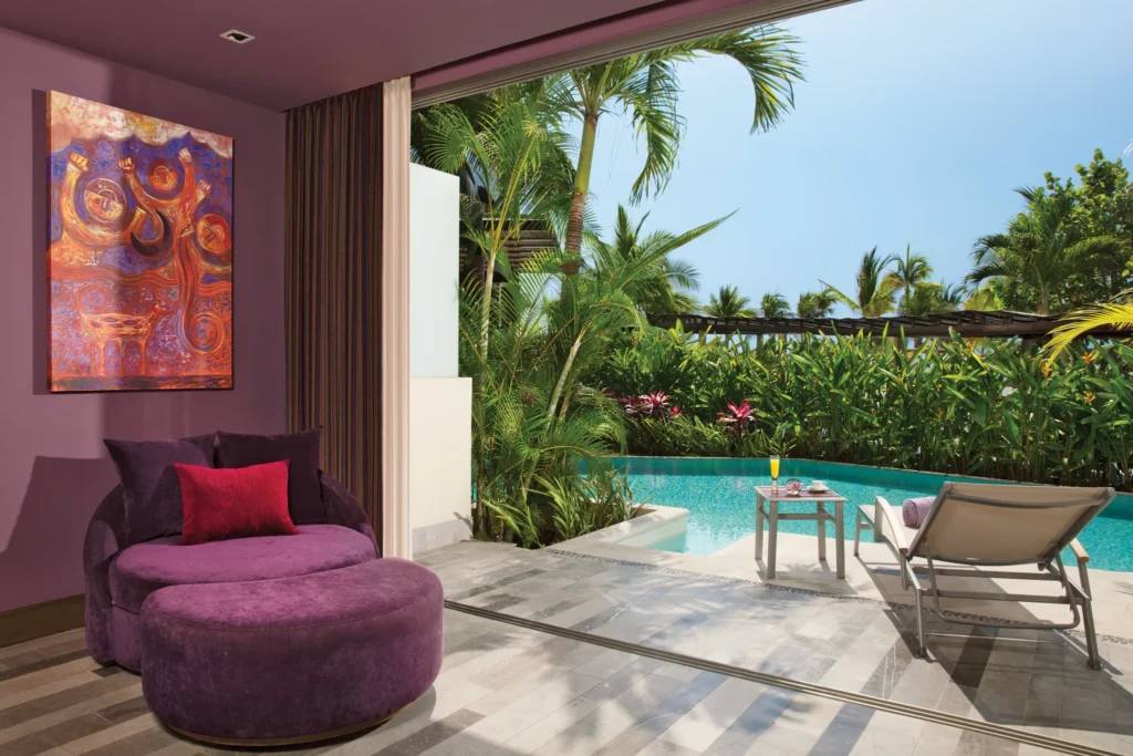 Preferred Club Master Suite Tropical View Swimout bedroom with king bed and separate living area at Secrets Vallarta Bay Puerto Vallarta.