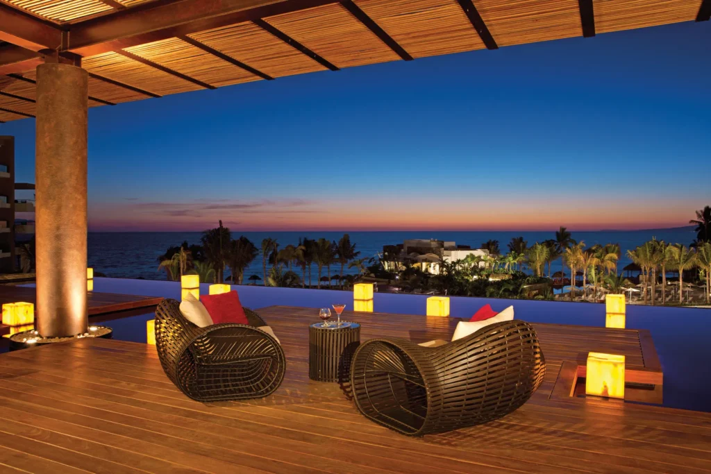 Romantic evening view from lobby terrace with ocean and sunset at Secrets Vallarta Bay Puerto Vallarta.
