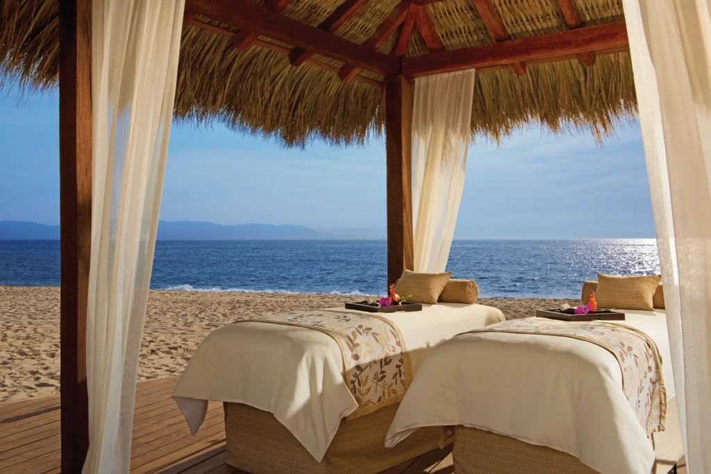Twin massage beds in a beach cabana overlooking the ocean at Secrets Vallarta Bay Puerto Vallarta.