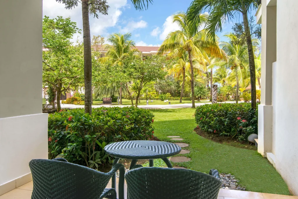 Junior Suite Garden View private furnished terrace overlooking tropical gardens at Secrets Wild Orchid Montego Bay.