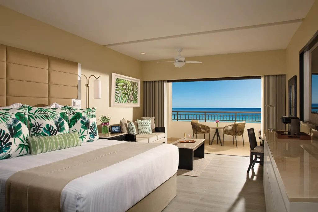 Junior Suite Ocean Front with king bed and balcony overlooking the Caribbean Sea at Secrets Wild Orchid Montego Bay.