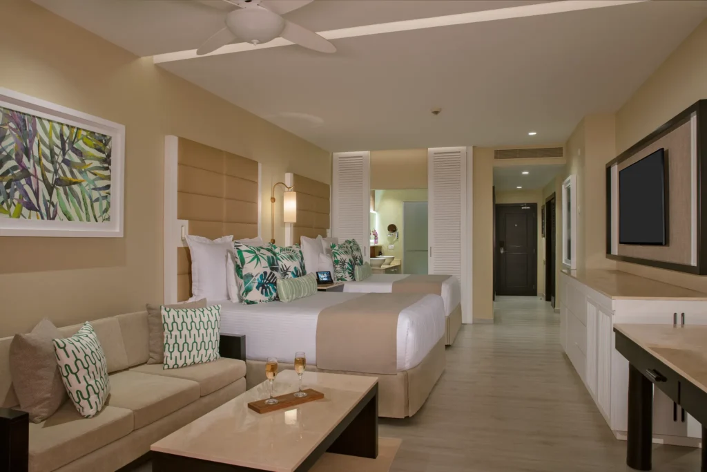 Junior Suite Ocean Front with two queen beds and sitting area at Secrets Wild Orchid Montego Bay.