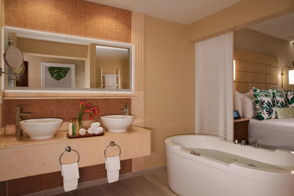 Junior Suite Ocean View bathroom with dual sinks and in-room hot tub at Secrets Wild Orchid Montego Bay.