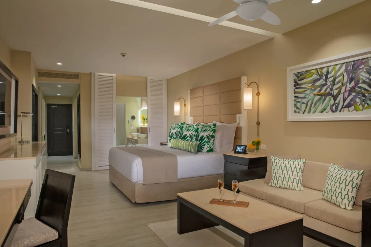 Junior Suite Ocean View with king bed and sitting area at Secrets Wild Orchid Montego Bay.