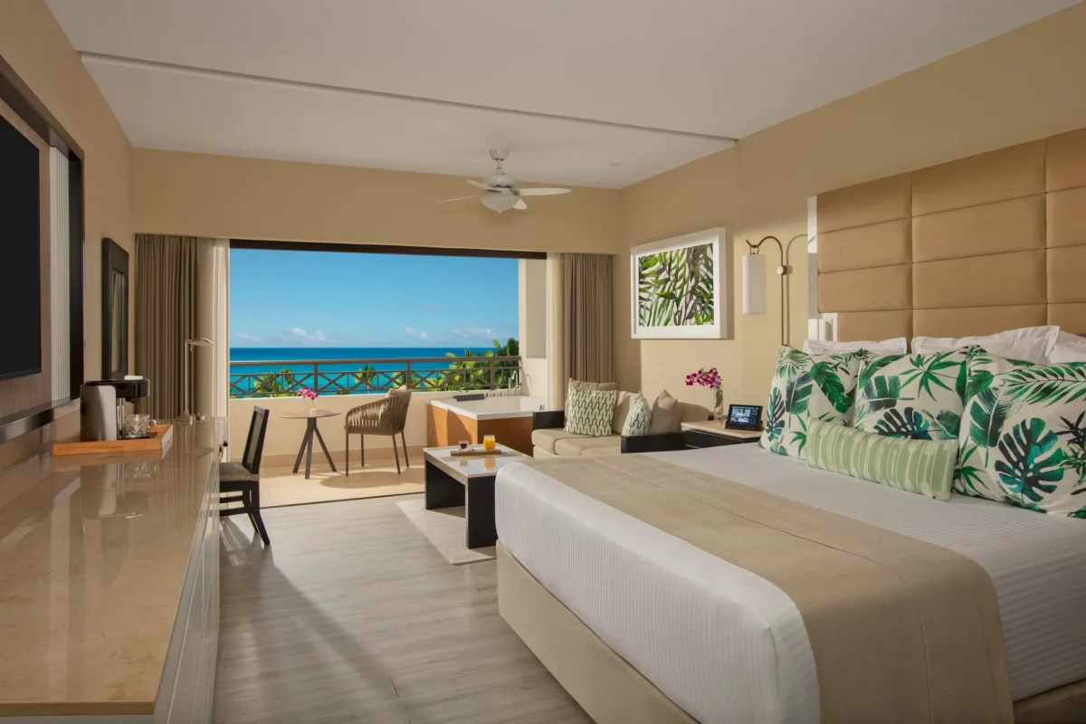 Preferred Club Junior Suite Ocean View with king bed and soaking tub on balcony at Secrets Wild Orchid Montego Bay.
