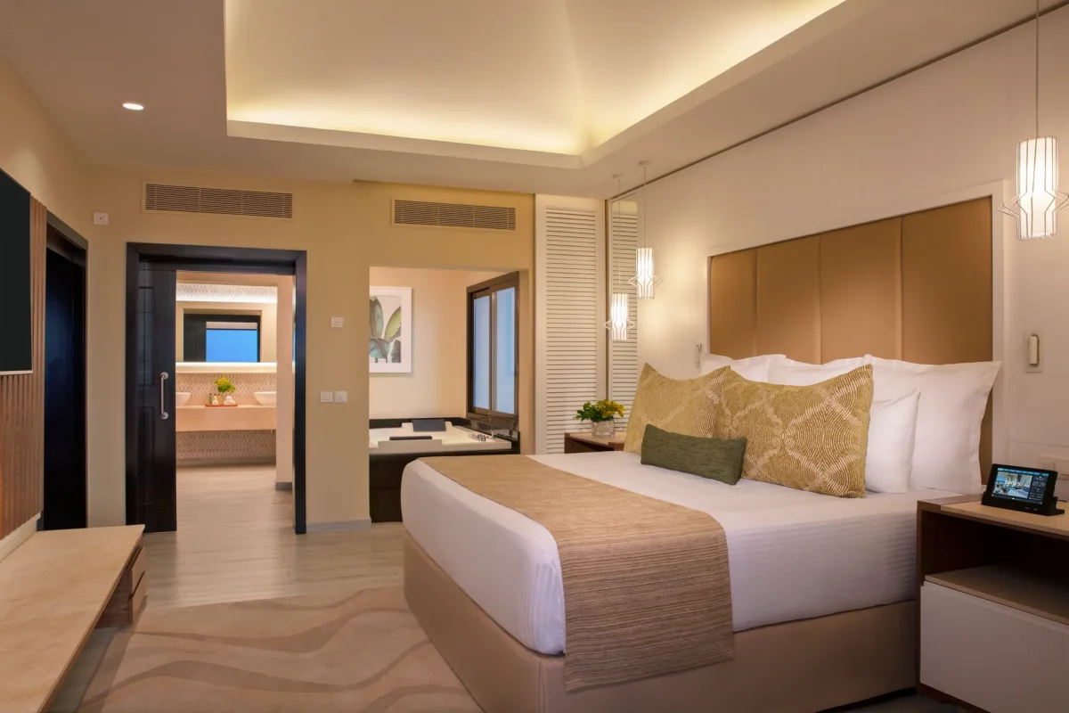 Preferred Club Master Suite Ocean Front Swim Out bedroom with king bed and terrace access at Secrets Wild Orchid Montego Bay.