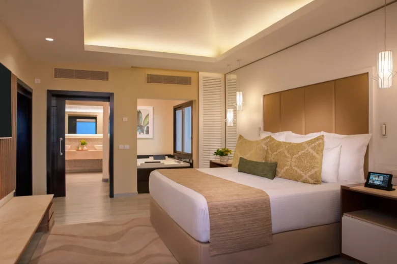 Preferred Club Master Suite Ocean Front Swim Out bedroom with king bed and terrace access at Secrets Wild Orchid Montego Bay.