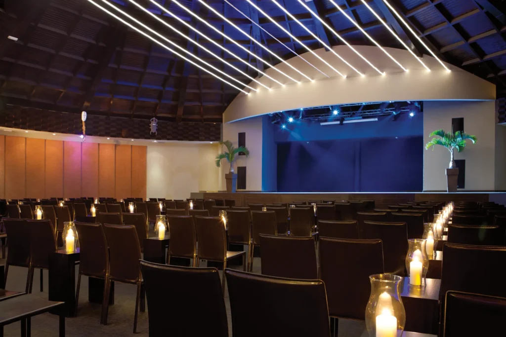 Elegant indoor theater with stage lighting and seating at Secrets Wild Orchid Montego Bay for live entertainment and events.