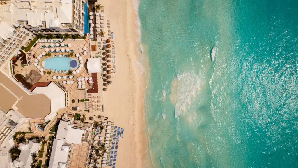 Top aerial view of Sunscape Cancun Resort & Spa with beachfront pool and turquoise Caribbean waters.