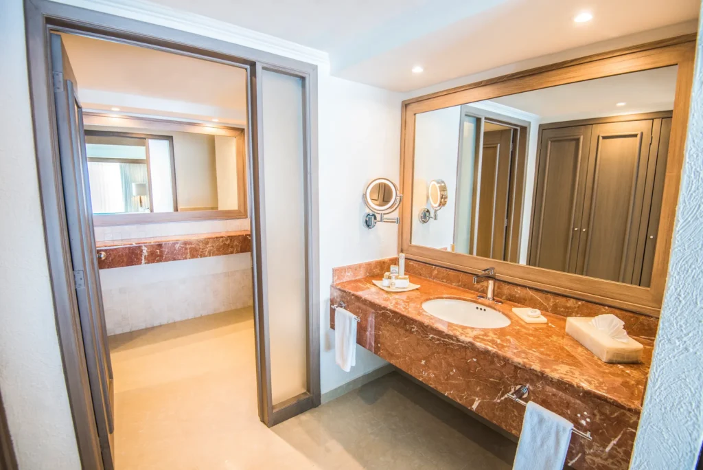 Deluxe Junior Suite bathroom with marble vanity at Sunscape Cancun Resort & Spa.