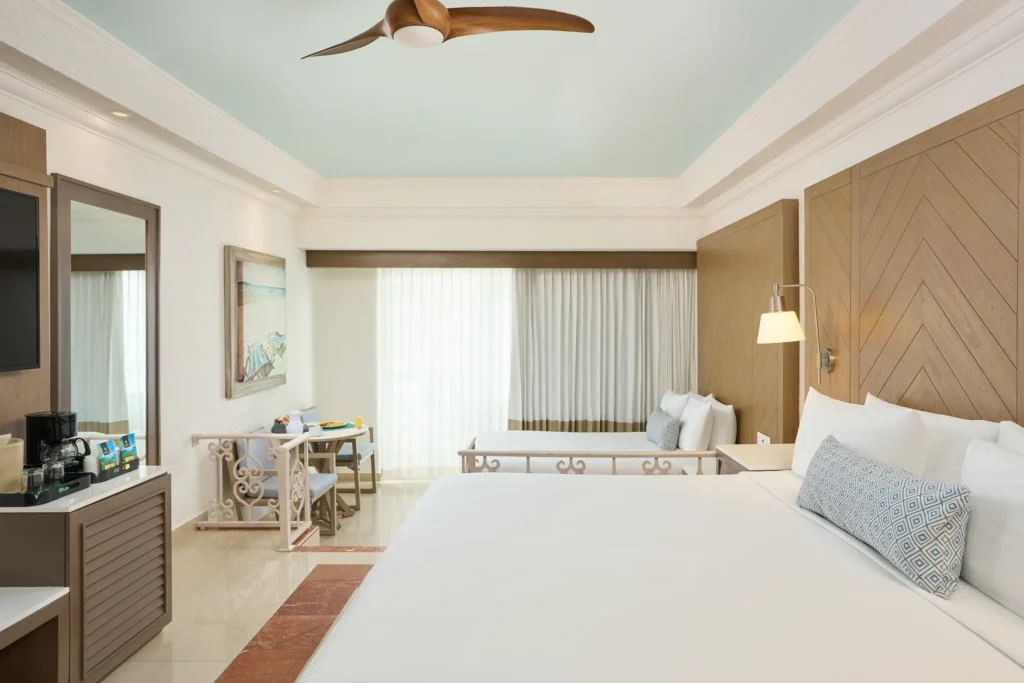 Deluxe Junior Suite interior with king bed at Sunscape Cancun Resort & Spa.