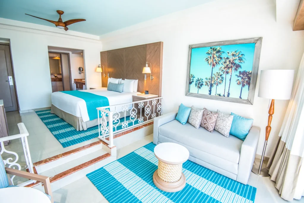 Deluxe Junior Suite sitting area with sofa at Sunscape Cancun Resort & Spa.