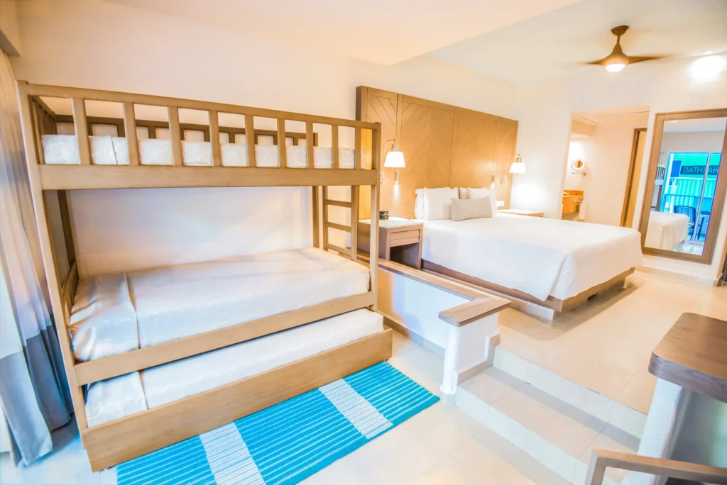 Family Junior Suite bunk beds and king bedroom area at Sunscape Cancun Resort & Spa.