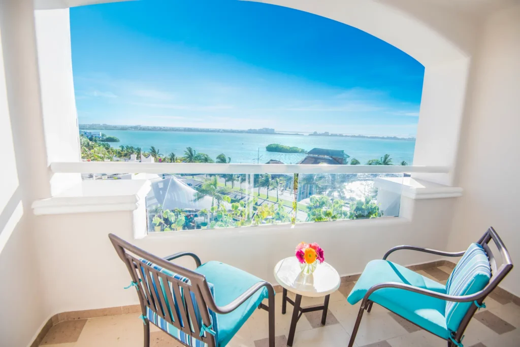 Junior Suite balcony with lagoon views and seating area at Sunscape Cancun Resort & Spa.