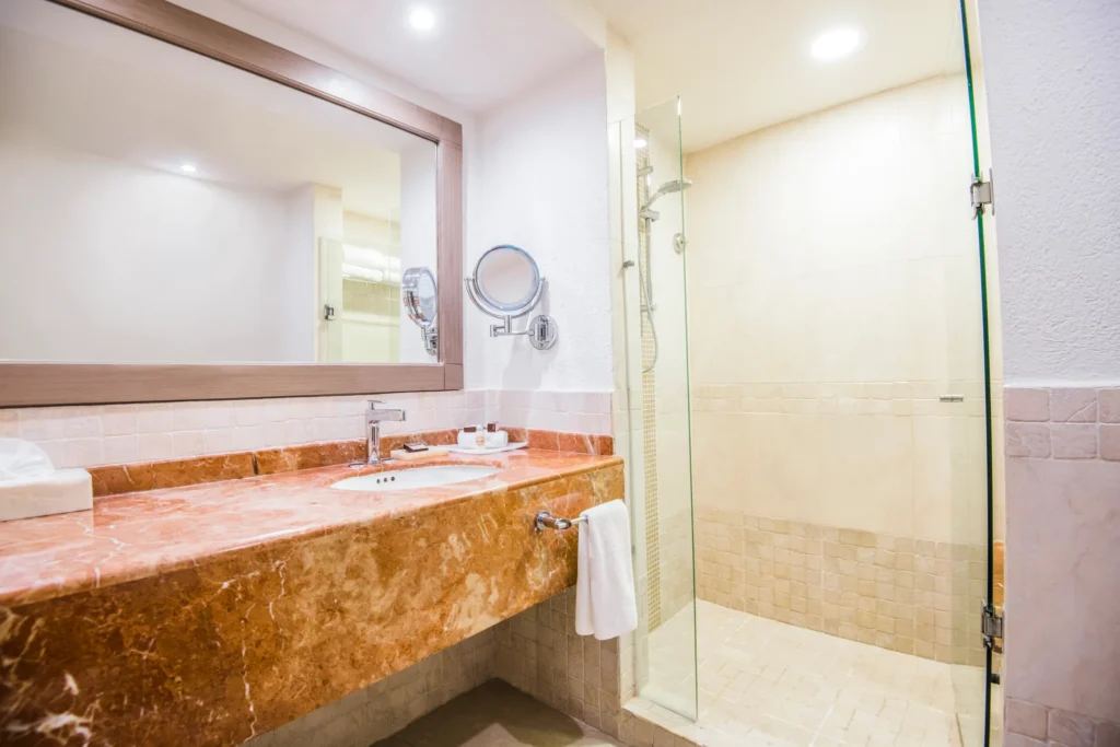 Junior Suite Beachfront bathroom with marble vanity at Sunscape Cancun Resort & Spa.