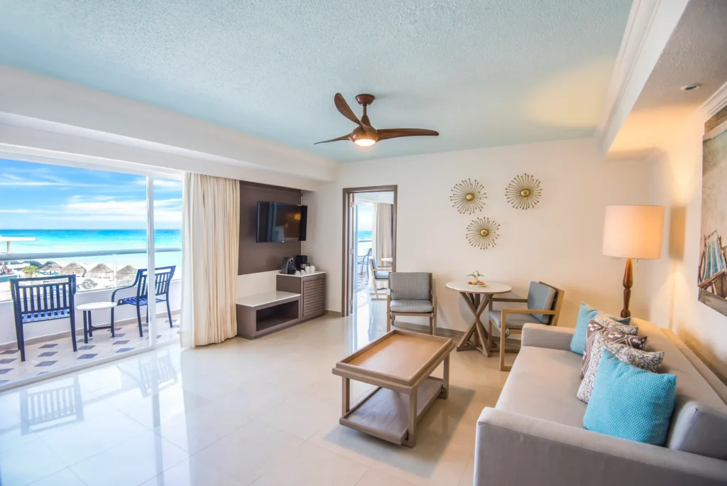 Sun Club Oceanfront Master Suite living area with oceanfront balcony at Sunscape Cancun Resort & Spa.
