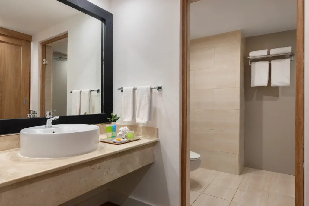 Deluxe Suite bathroom with modern vanity and walk-in shower at Sunscape Coco Punta Cana.