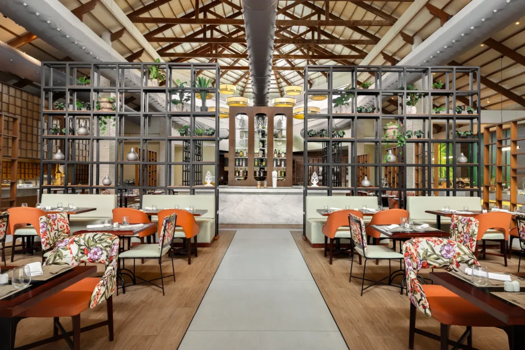 Kaleidoscope restaurant at Sunscape Coco Punta Cana featuring colorful contemporary décor, elegant dining tables, and an inviting international buffet atmosphere.