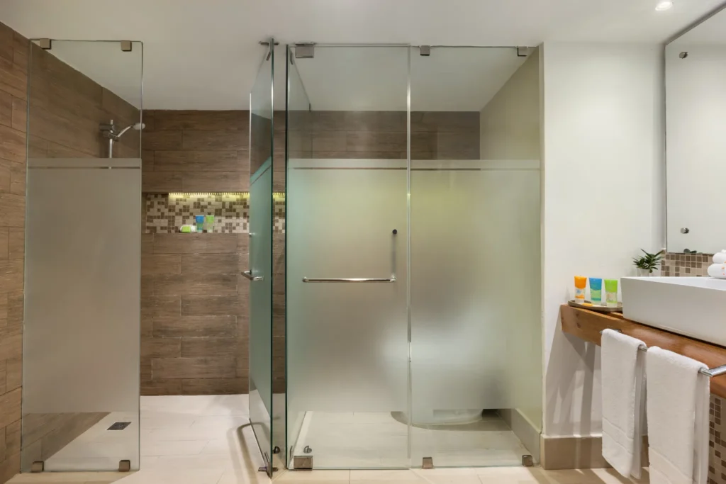 Sun Club 3-Bedroom Family Suite Tropical View bathroom with glass walk-in shower at Sunscape Coco Punta Cana.