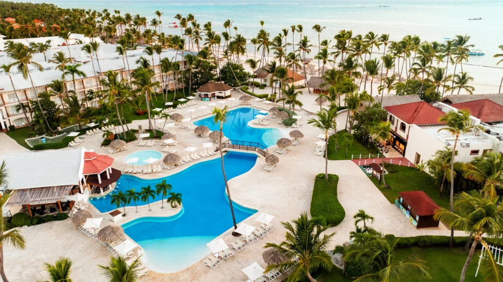 Aerial view of the main resort pool and beachfront at Sunscape Coco Punta Cana.