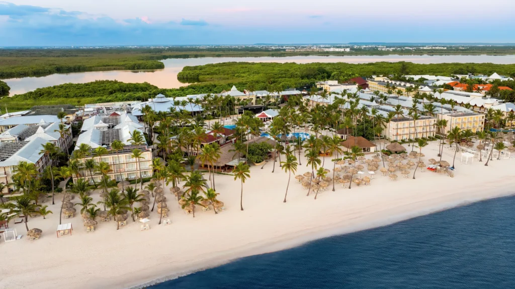 Aerial beachfront view of Sunscape Coco Punta Cana Resort and white sand beach.