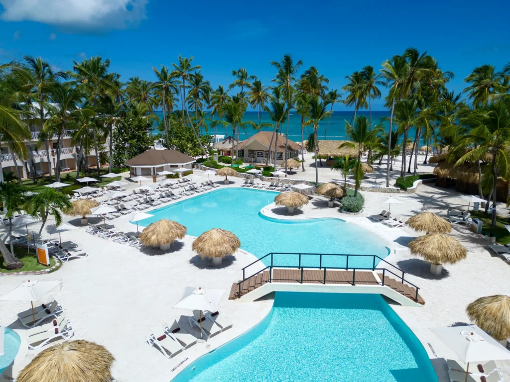 Aerial view of the main pool area with beach access at Sunscape Coco Punta Cana Resort.