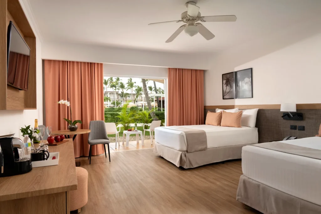 Superior Deluxe Tropical View room with two double beds and garden-view terrace at Sunscape Coco Punta Cana.