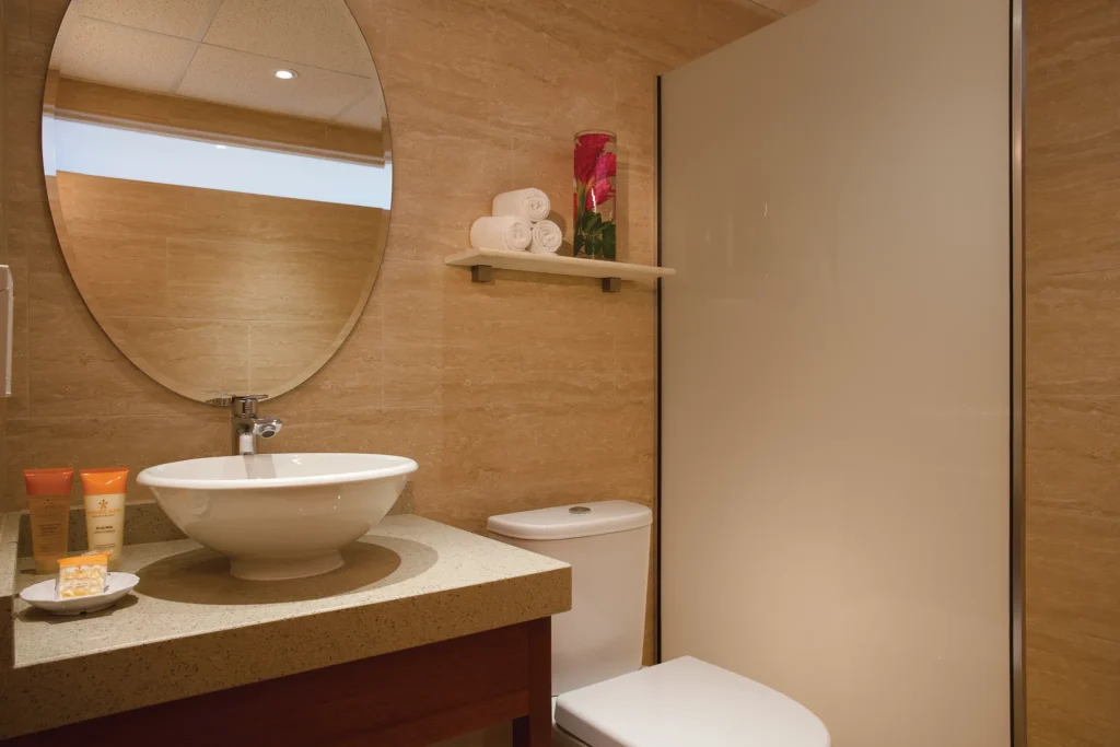 Deluxe Ocean View bathroom with vanity sink and walk-in shower at Sunscape Curaçao Resort.
