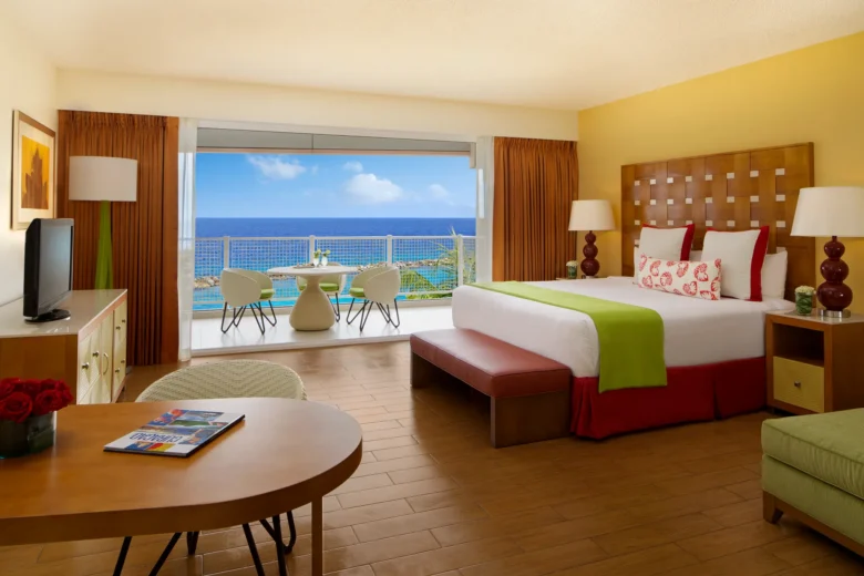 Deluxe Ocean View king room with private balcony overlooking the Caribbean at Sunscape Curaçao Resort, Spa & Casino.