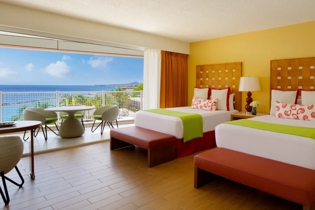 Deluxe Ocean View room with two double beds and balcony at Sunscape Curaçao Resort, Spa & Casino.