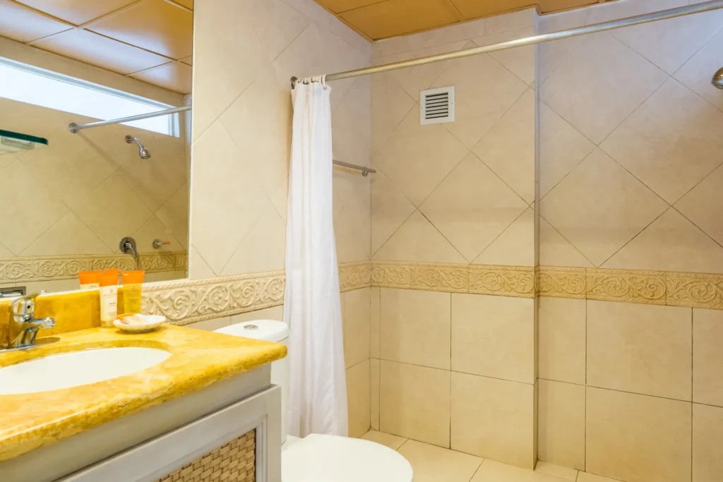 Sun Club Premium Deluxe Ocean Front bathroom with vanity sink and walk-in shower at Sunscape Curaçao Resort.