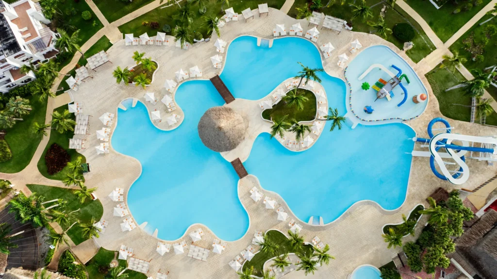 Overhead view of beach loungers, palm trees, and shoreline at Sunscape Dominicus La Romana.