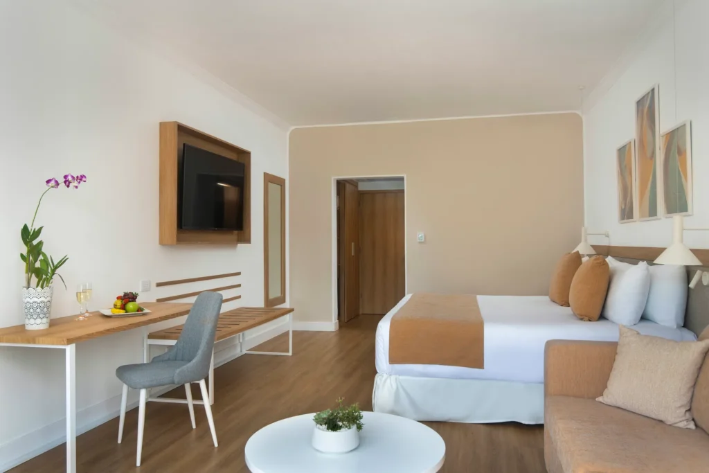 Deluxe Partial Ocean View king room with sofa, desk, and modern décor at Sunscape Dominicus La Romana.