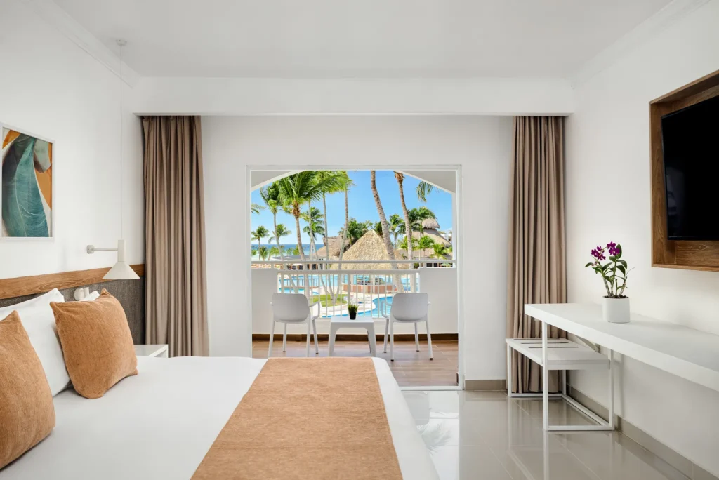 Deluxe Pool View king room with private balcony overlooking pool at Sunscape Dominicus La Romana.