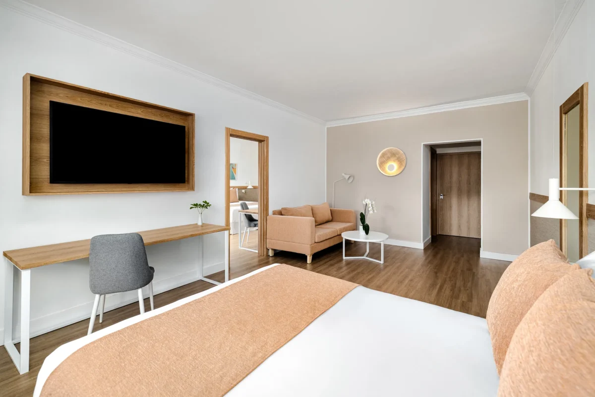 Deluxe Two Bedroom Family Suite with king bed, living area, and sofa at Sunscape Dominicus La Romana.