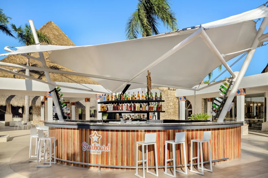 Starboard lobby bar at Sunscape Dominicus La Romana featuring stylish indoor seating, cocktails, and a relaxed social atmosphere.