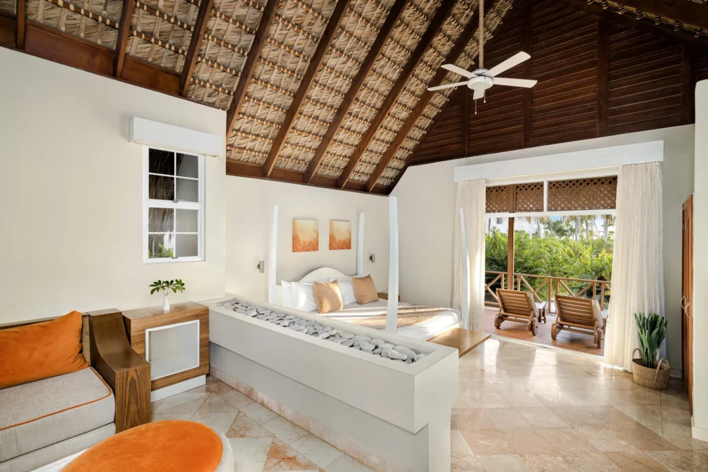 Sun Club Honeymoon Villa Tropical View with king canopy bed, vaulted thatched ceiling, and private terrace at Sunscape Dominicus La Romana.