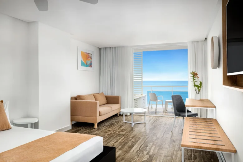Sun Club Superior Ocean View king room with sofa and private balcony overlooking the ocean at Sunscape Dominicus La Romana.