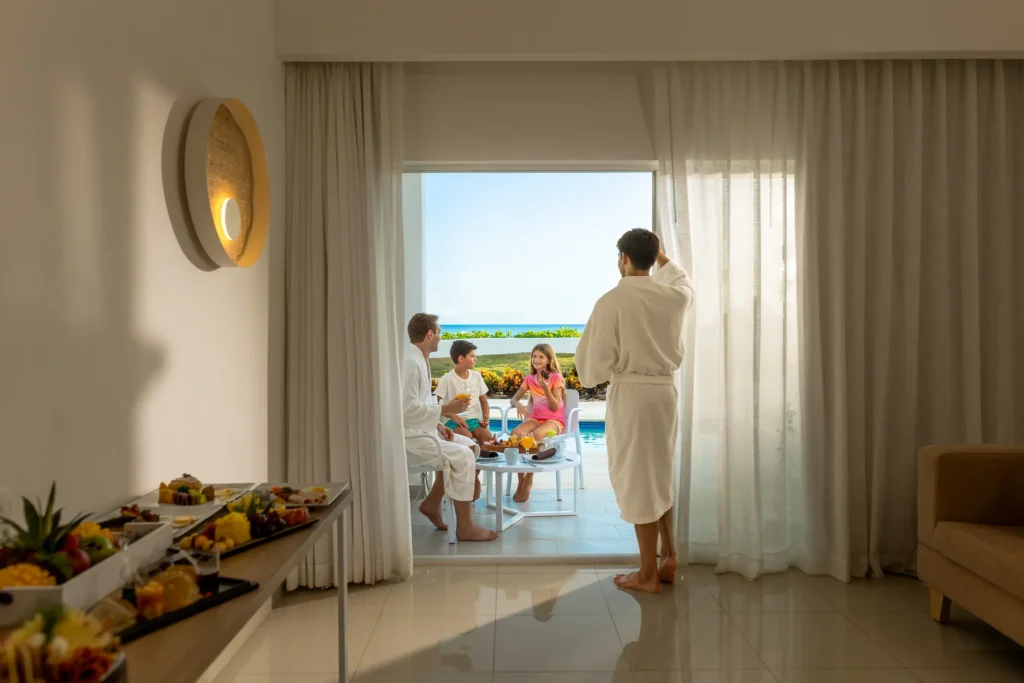 Family enjoying breakfast on a private terrace with ocean views at Sunscape Dominicus La Romana resort.