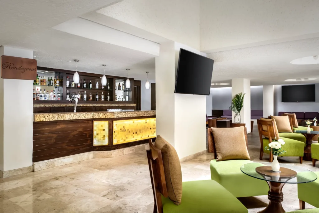 Rendezvous Lobby Bar at Sunscape Dorado Pacifico Ixtapa featuring a stylish indoor bar, lounge seating, and modern décor.