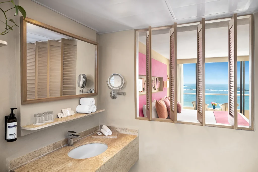 Sun Club Deluxe Ocean View king bathroom with marble countertop and vanity mirror at Sunscape Dorado Pacifico Ixtapa.