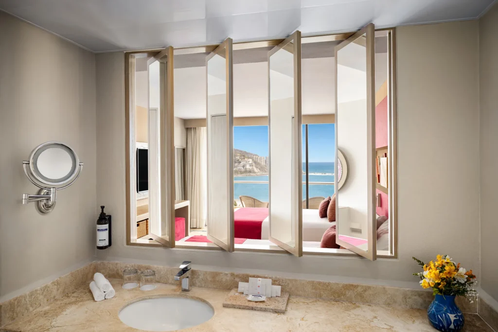 Sun Club Family Connecting bathroom with marble vanity and mirror at Sunscape Dorado Pacifico Ixtapa.
